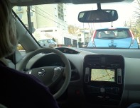 Ellen behind the wheel of a Nissan Leaf