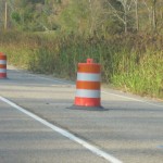 Orange safety cones at edge of highway
